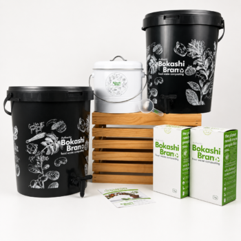 Bokashi composting kit — two black buckets with taps, white kitchen caddy on a wooden stand, and 2 x 1kg Bokashi Bran.