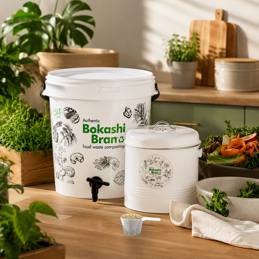 Deluxe counter caddy with Bokashi Bran bucket and scoop on a wooden counter with vegetable scraps in the background.